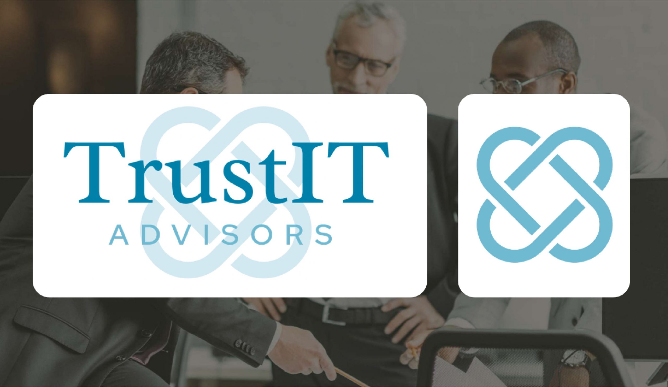 Three professionals in business attire, likely IT consultants, are engaged in discussion at a desk. The foreground prominently features the TrustIT Advisors logo and symbol in blue and white, partially obscuring the group—a nod to their proud Texas roots and expert logo design.