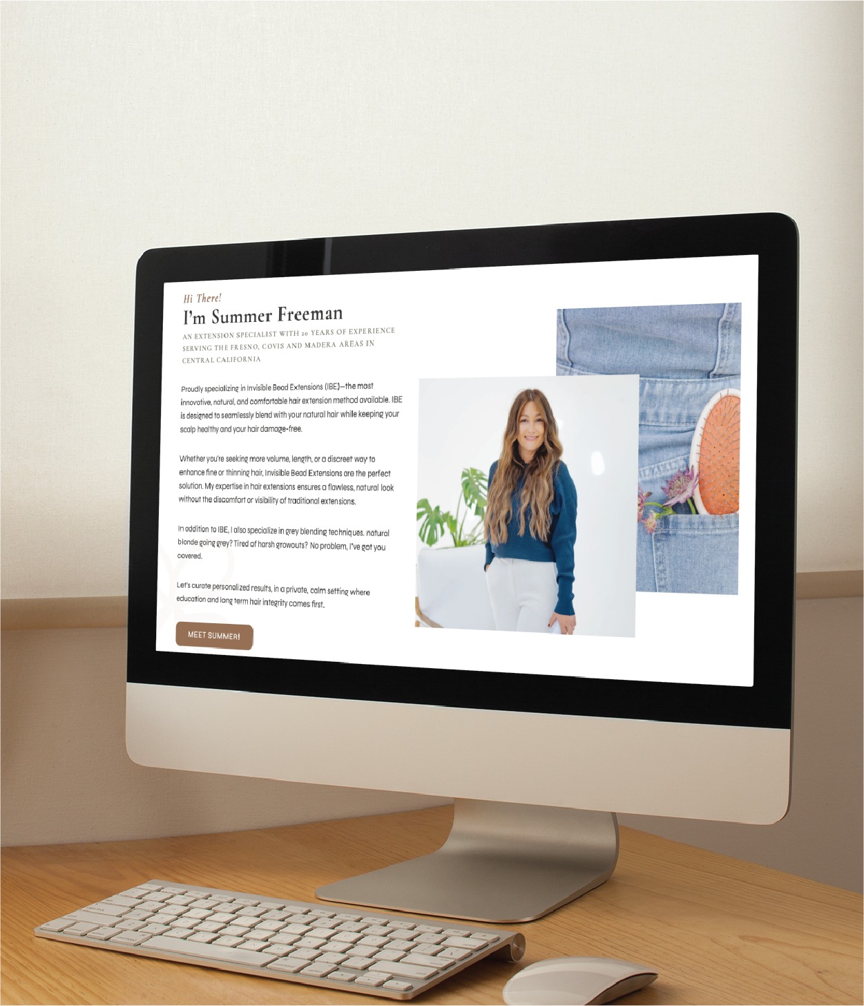 A desktop computer on a desk displays a website featuring an introduction to Sumter Freeman, showcasing her portrait, biography, and a denim jacket with an orange—all thoughtfully arranged through modern website design.