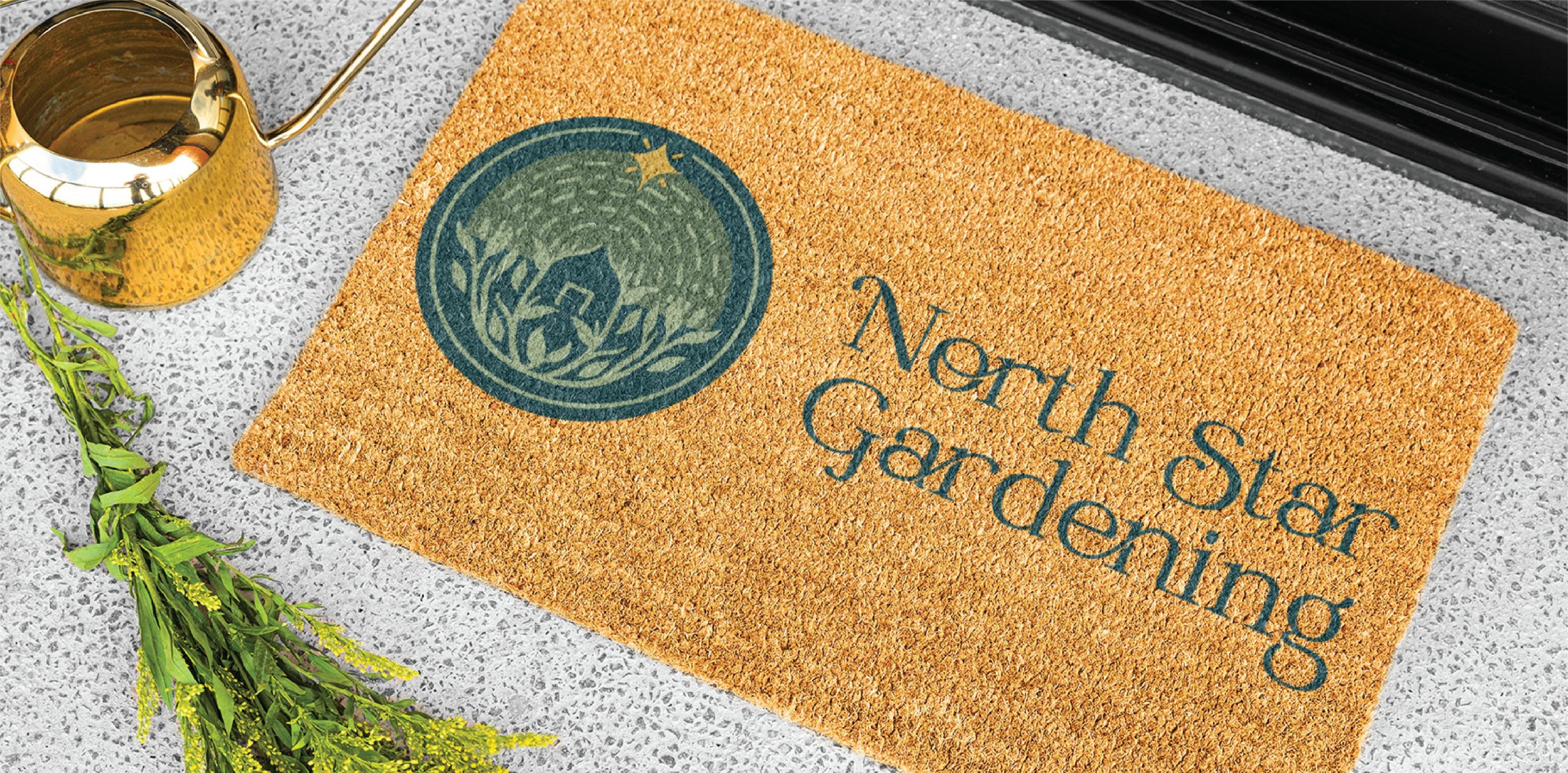 A doormat with a green North Star Gardening logo illustration and text, reflecting a passion for garden care, sits next to a gold watering can and lush green foliage, placed on a light speckled floor.