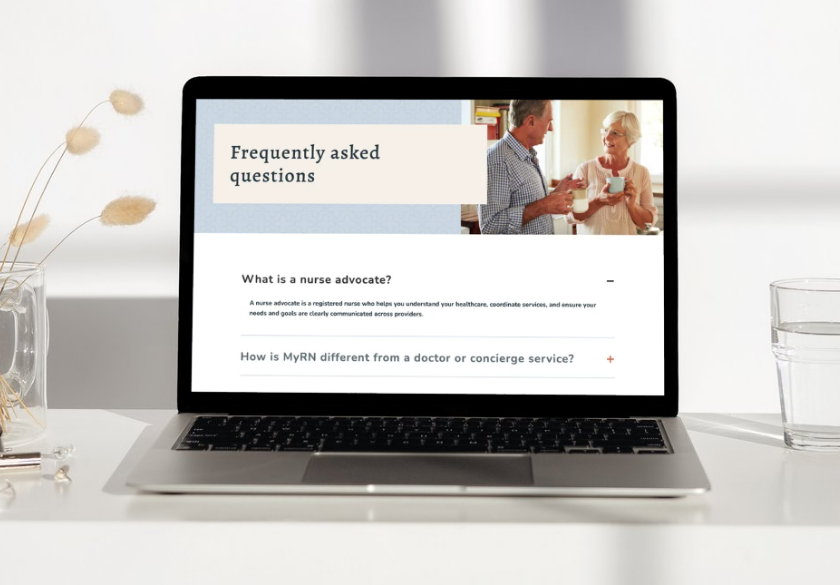 A laptop on a table displays a FAQ page about nurse advocates, emphasizing website credibility, with an image of two people talking and holding mugs. Dried plants, a glass of water, and a notebook are nearby.