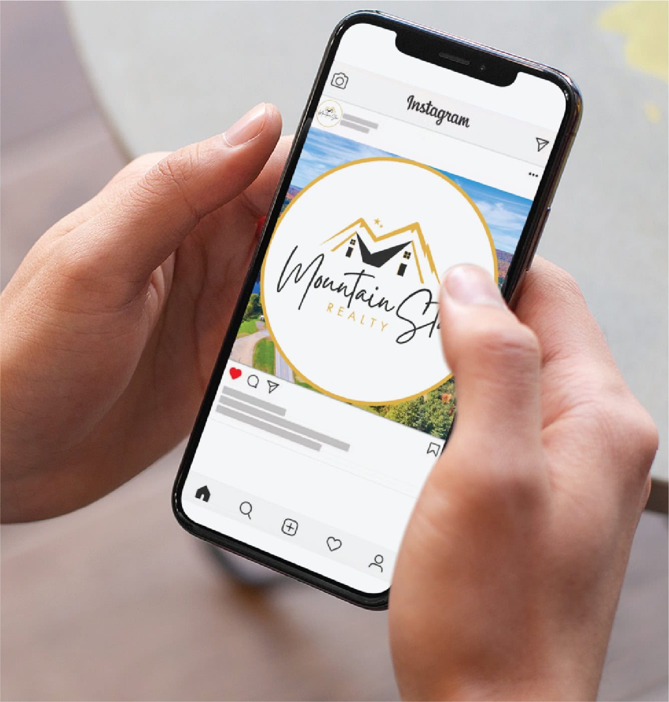 A person holds a smartphone displaying an Instagram post featuring the Mountain Sky Realty logo with a gold circle and stylized mountain design, showcasing their custom social media design expertise in Michigan.