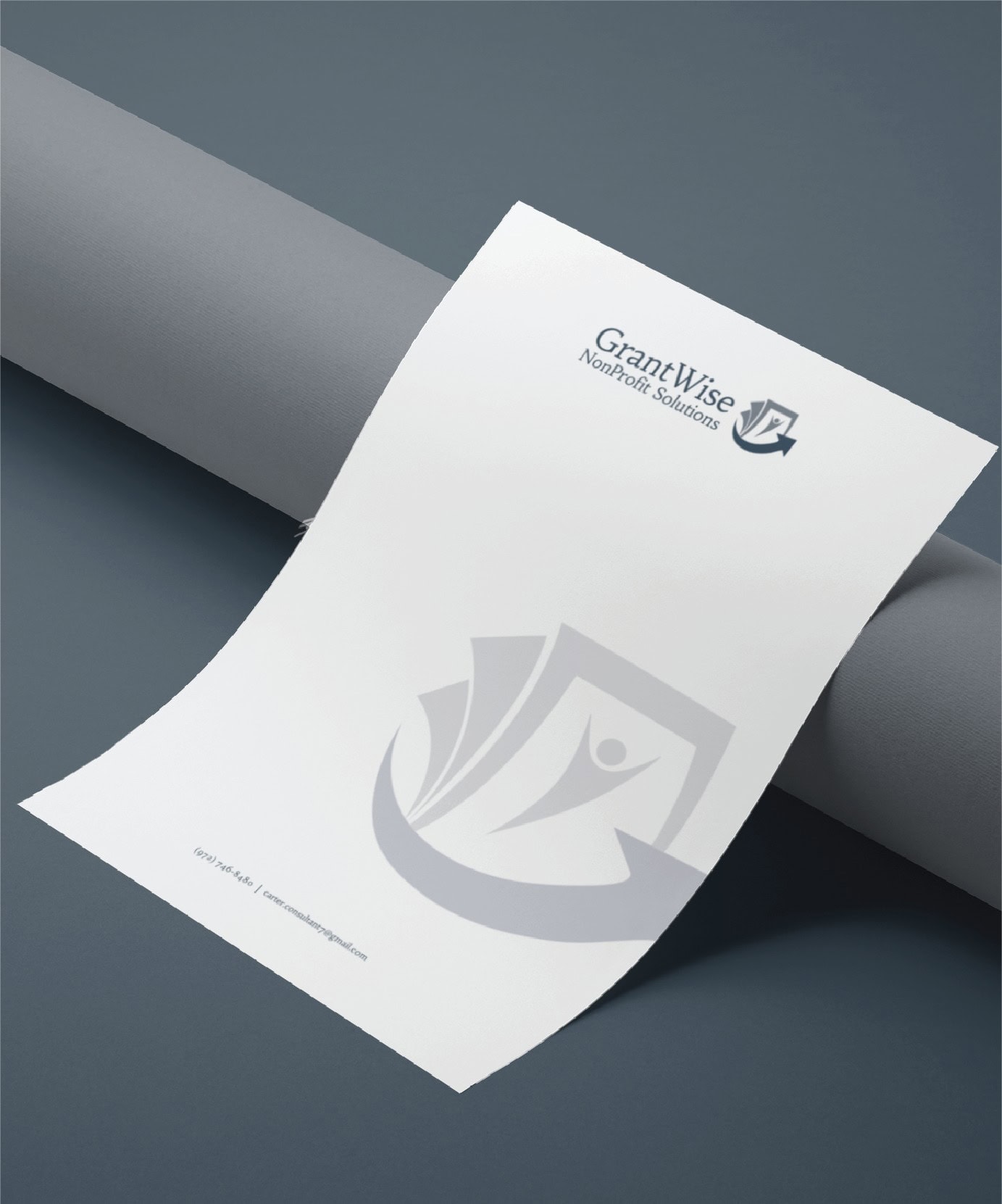 A sheet of letterhead paper with the GrantWise Nonprofit Solutions logo and name at the top right, and a large faint logo watermark across the page, showcases expert print design. Perfect for organizations in Pennsylvania, it is placed on a gray surface next to a cylindrical object.