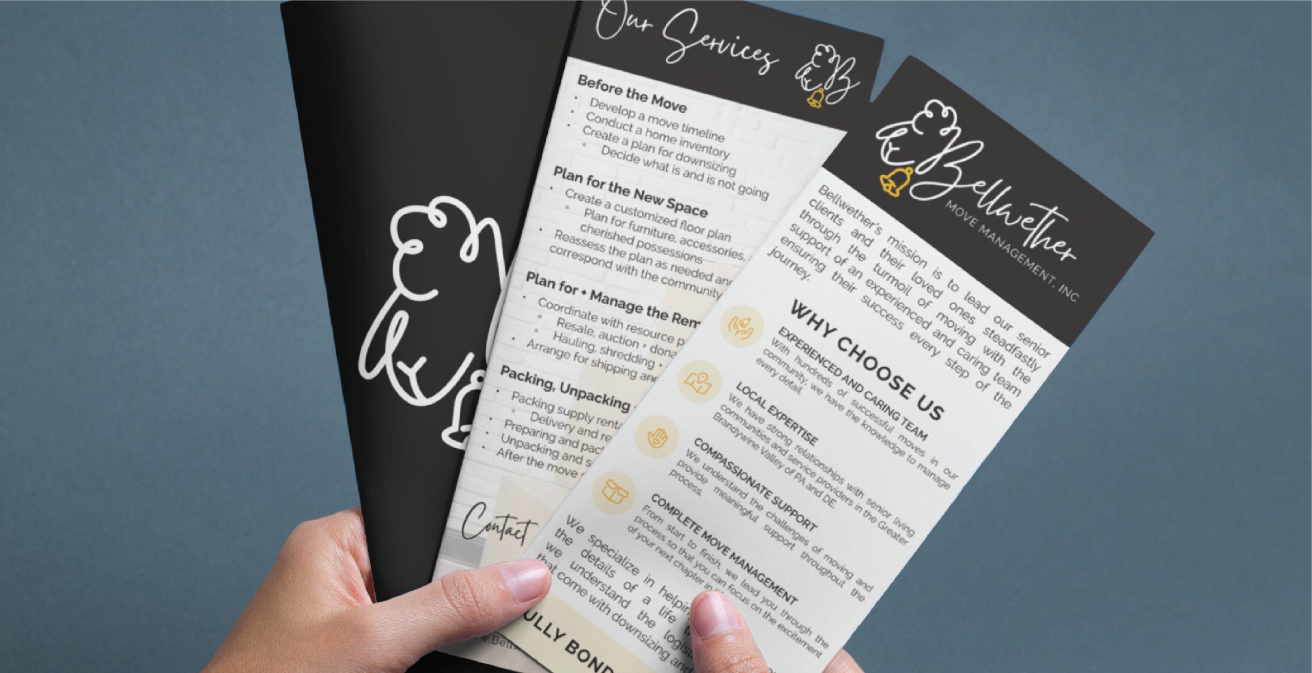 A person holds two Bellwether Moving Company brochures detailing services, tips for moving, reasons to choose the company, and contact information. The eye-catching print design features black, white, and cream colors with handwritten-style fonts. Highlighting their expertise in Move Management across Pennsylvania, these brochures convey professionalism and local reliability.