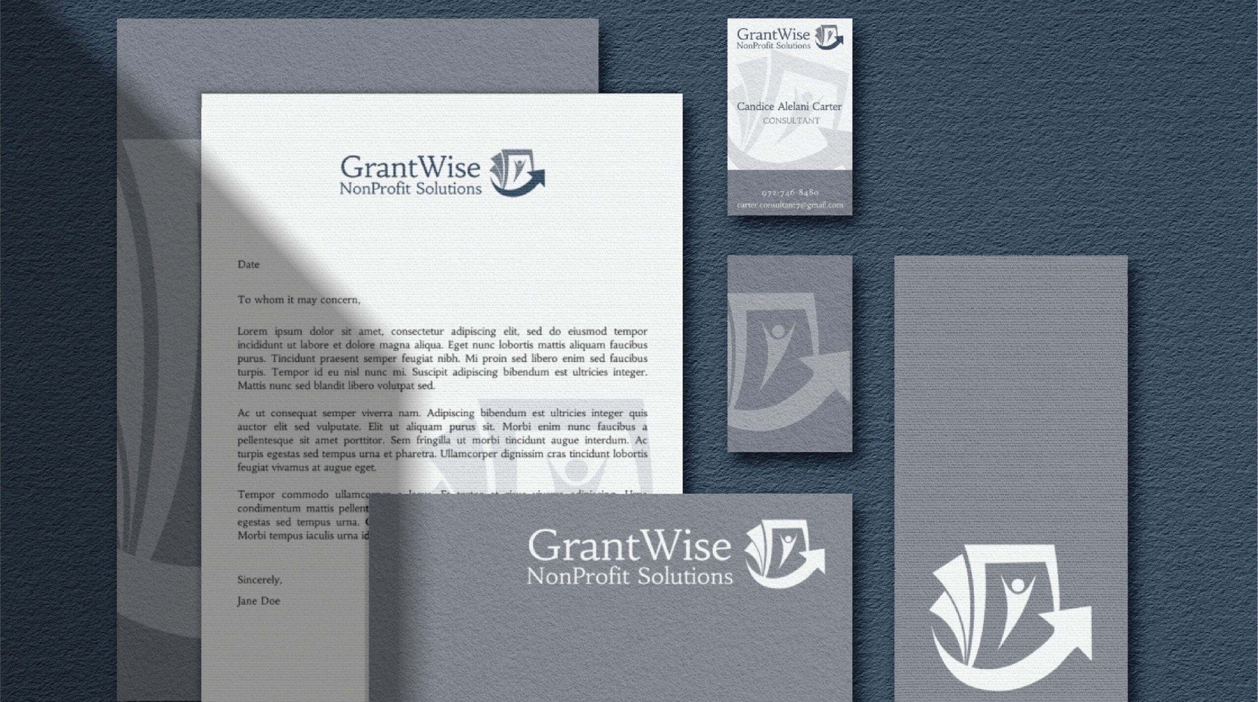 GrantWise branding materials, including a letterhead, business card, and folder, all featuring a blue and white logo with a stylized G and quill pen, are displayed on a textured blue background. This cohesive print design is ideal for businesses in Pennsylvania seeking professional branding solutions for sectors such as Move Management.