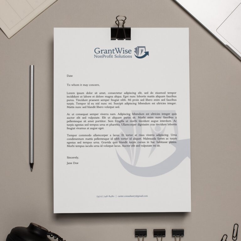 A letter on a clipboard with the GrantWise NonProfit Solutions logo at the top, resting on a beige desk in Pennsylvania with a pencil, notebook, and two binder clips nearby. The letter, featuring thoughtful print design elements, is signed by Jane Doe.