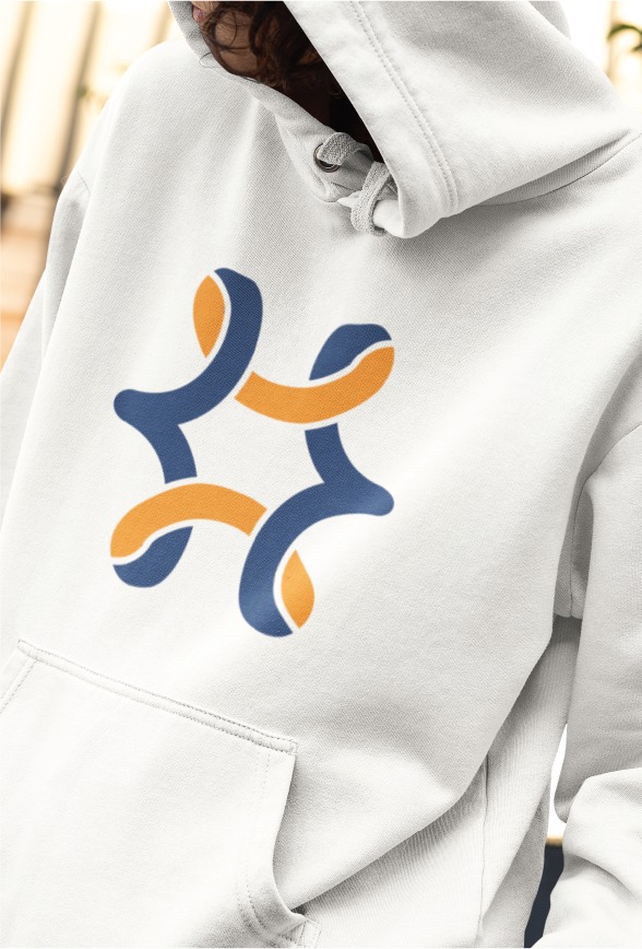 Person wearing a light-colored hoodie with a blue and orange abstract geometric design on the front, inspired by the vibrant energy of New Orleans. The person’s face is partially obscured by the hood.