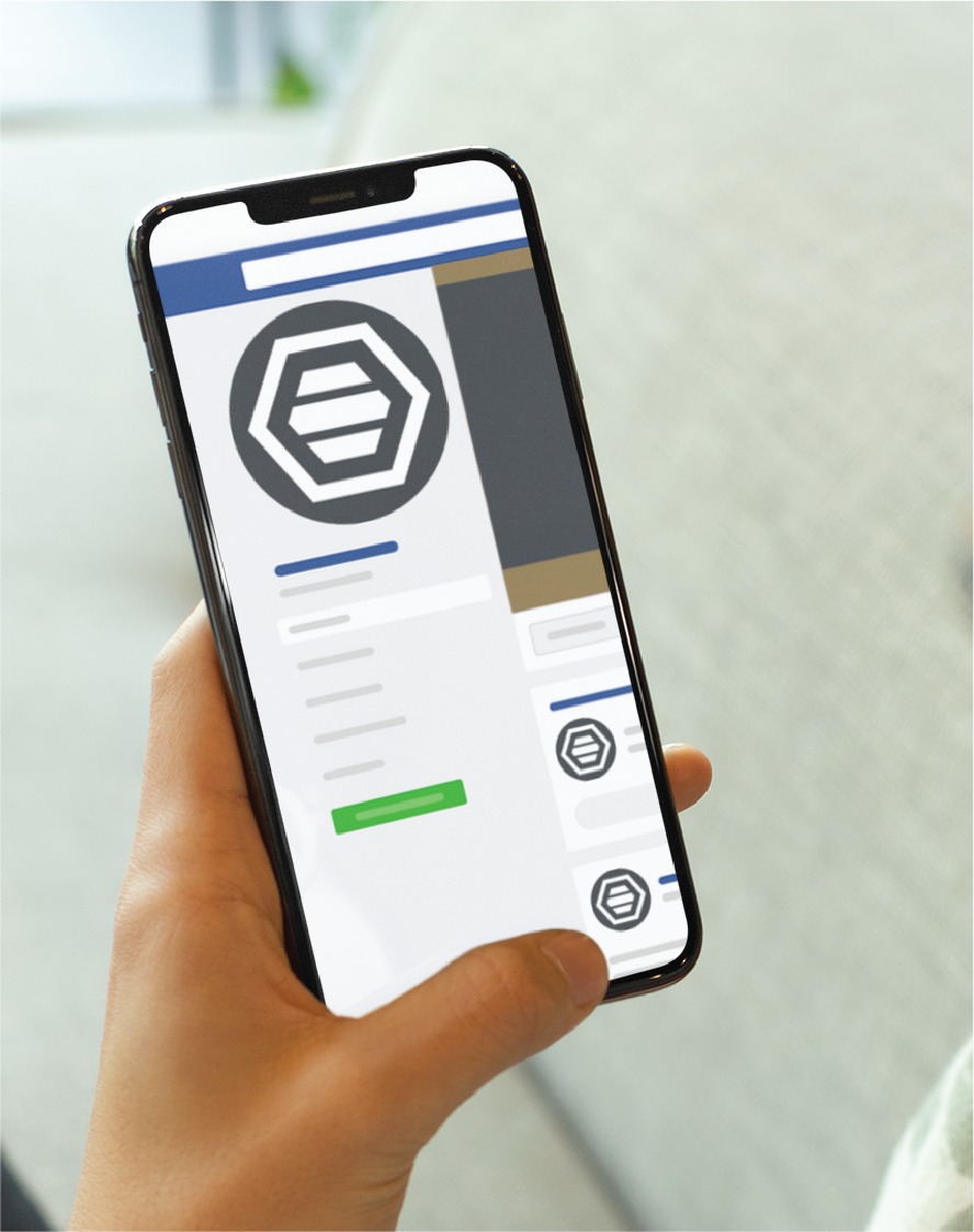 A person holds a smartphone displaying a social media profile with a hexagon logo and various blurred details on the screen, showcasing a Custom Social Media Design for a Michigan Contractor.