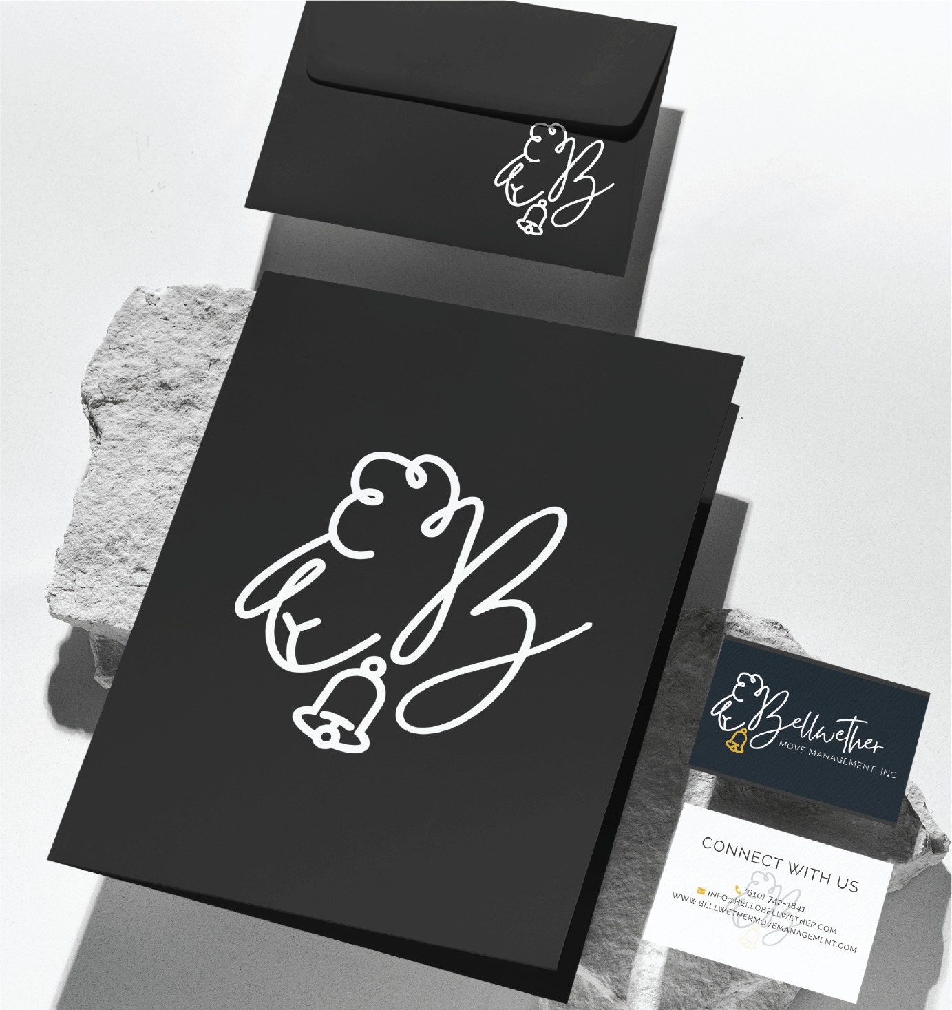 Black stationery set with a white bell and script logo includes an envelope, folder, and business cards displayed on light stone surfaces. Showcasing custom print design details for Bellwether Body Management, Inc., the business cards feature contact information and highlight their Move Management expertise across Pennsylvania.