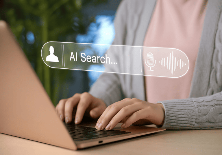 A person typing on a laptop with an AI search overlay, featuring a microphone icon and a sound wave, to optimize an SEO strategy.
