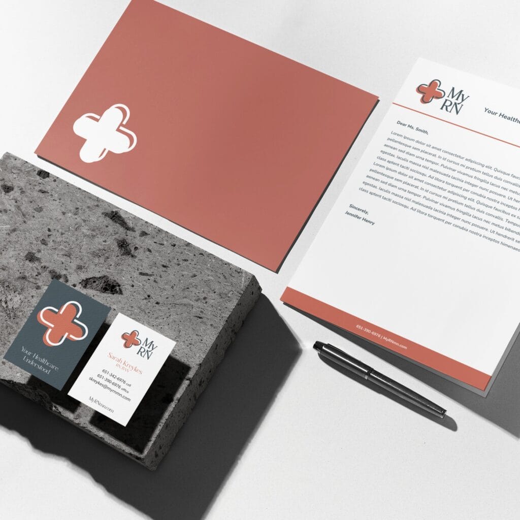 Branding materials for My RN, including a letterhead, business card, and pen, arranged on a concrete block for a Texas accountant.