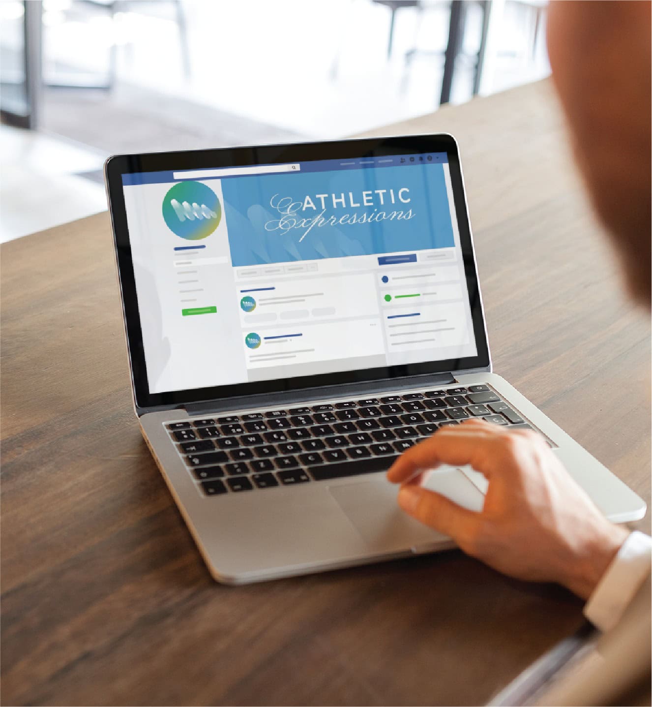 A person using a laptop to view an Athletic Expressions social media profile page, showcasing their sports performance coaching services.