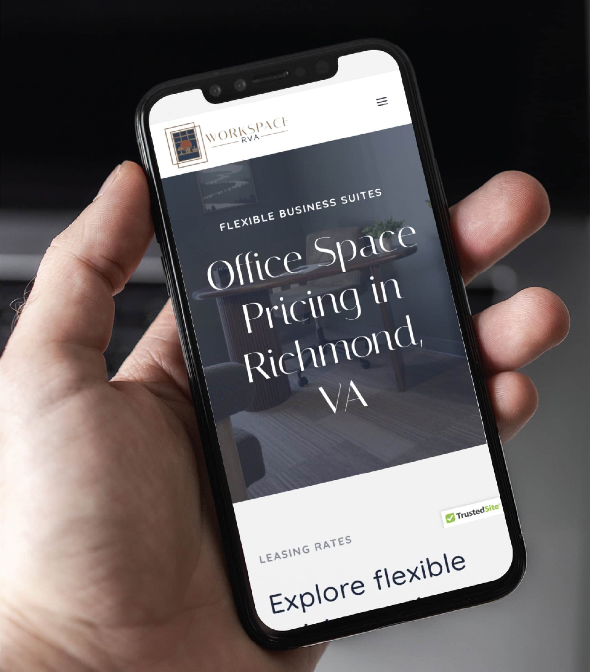 A hand holds a smartphone displaying a website offering office space pricing in Richmond, VA, with the TrustedSite badge—showcasing flexible business suites and expert website design for modern professionals.
